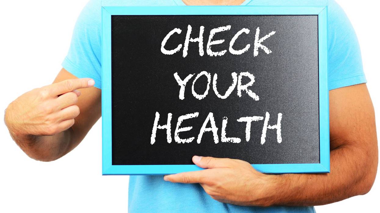 Person in blue shirt holds a blue-framed sign with 'CHECK YOUR HEALTH' and points.