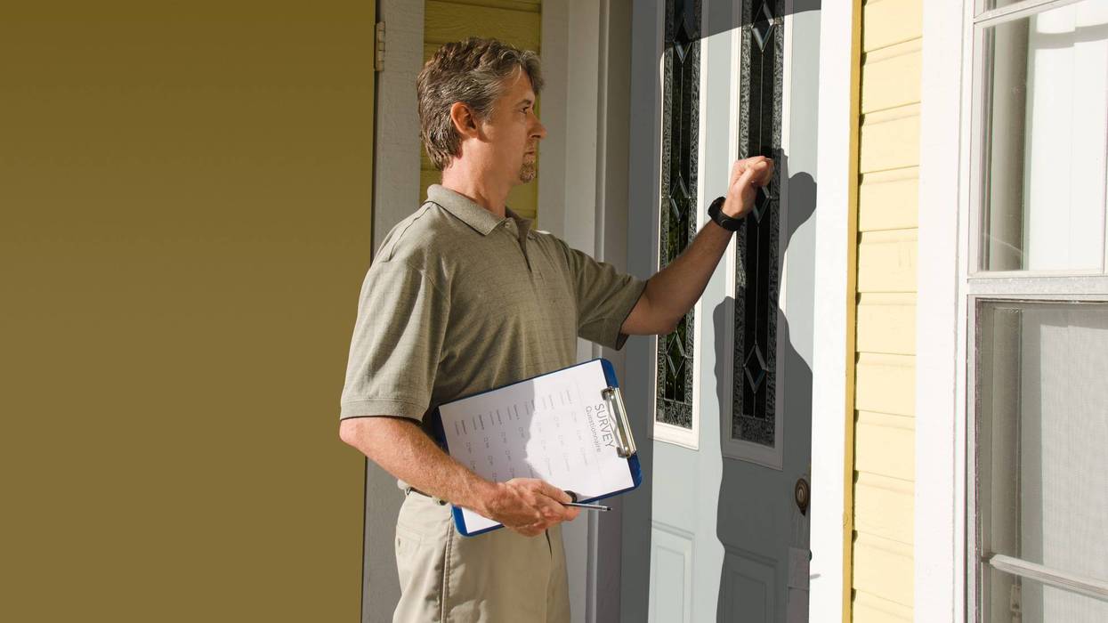 person knocking on door with clipboard