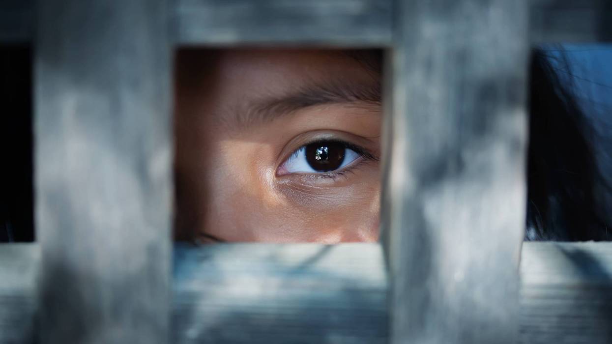 person lookin through bars