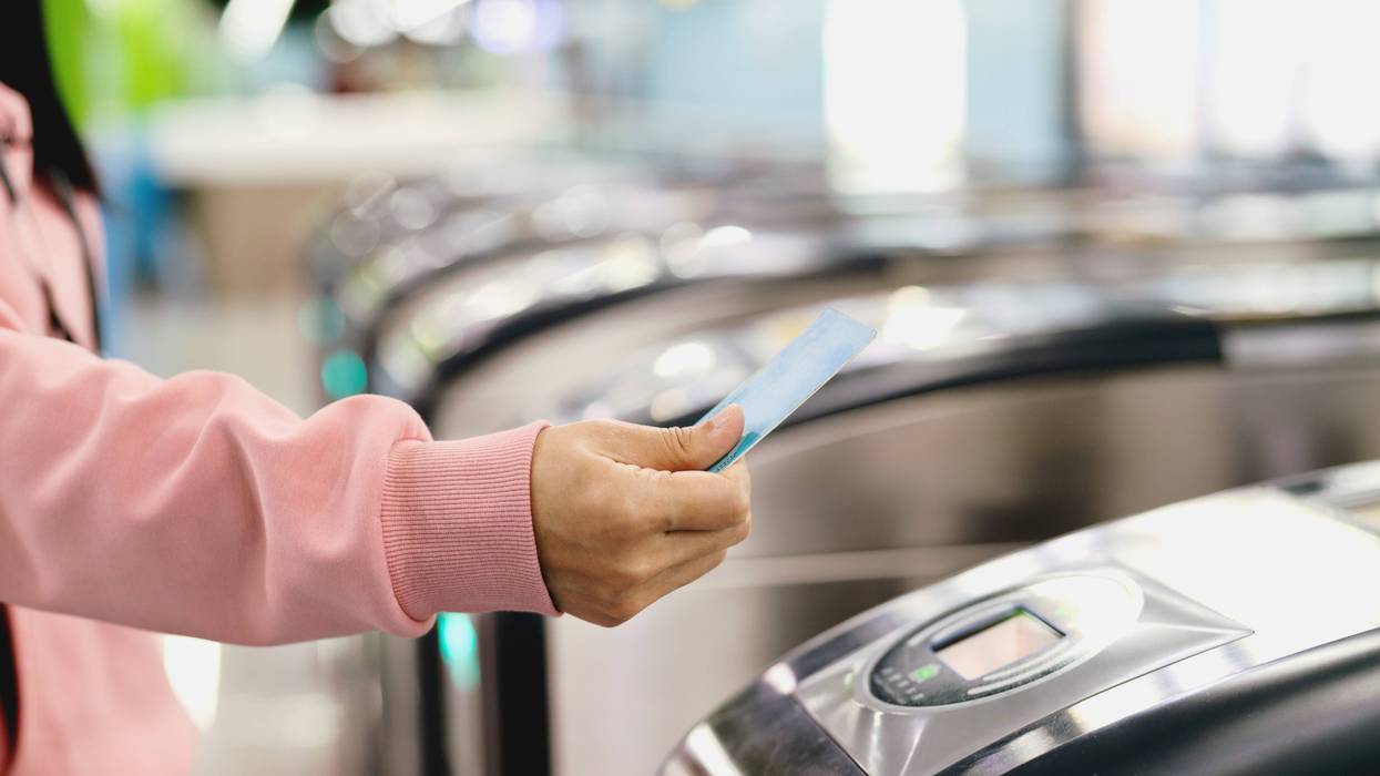 person paying for a train ride