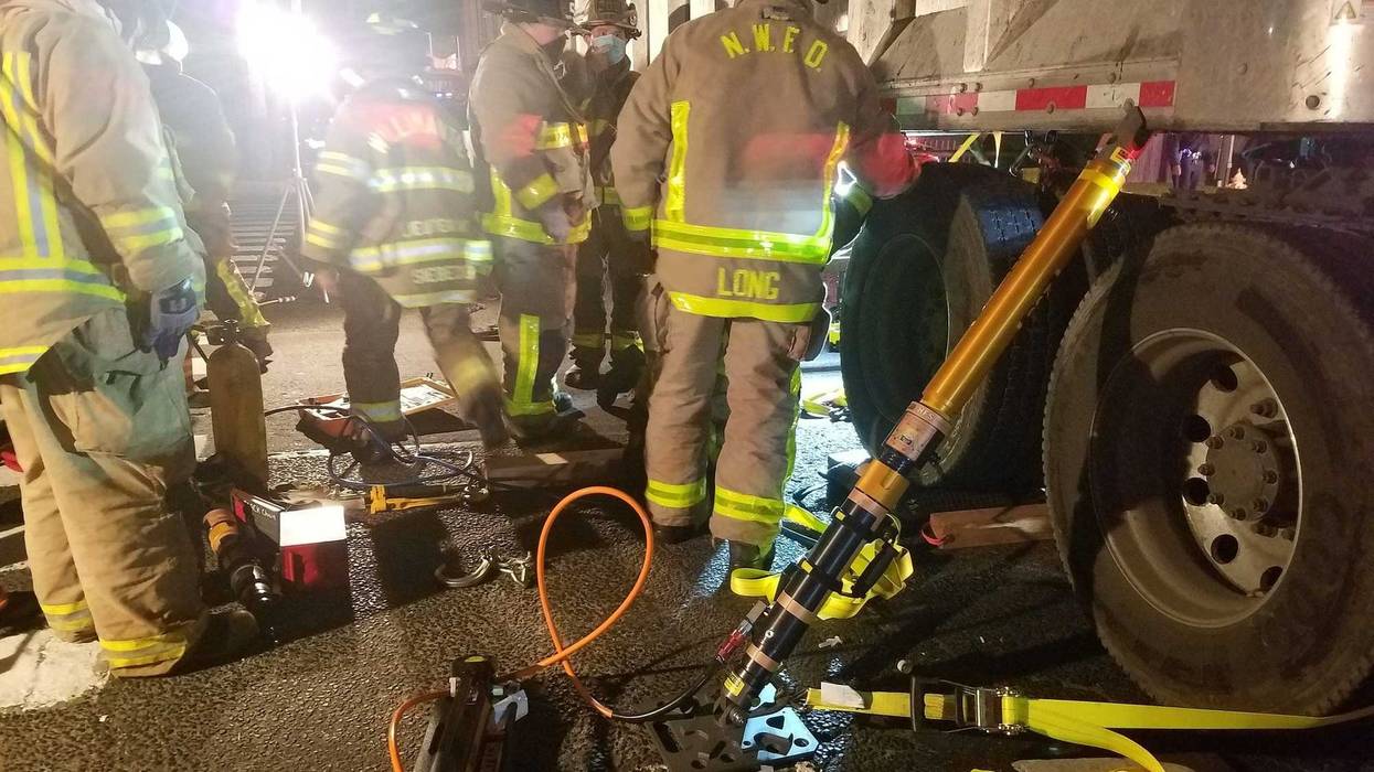 Person pinned under tractor trailer