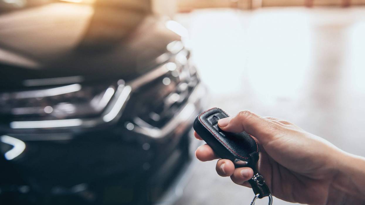 Person using key fob to lock car