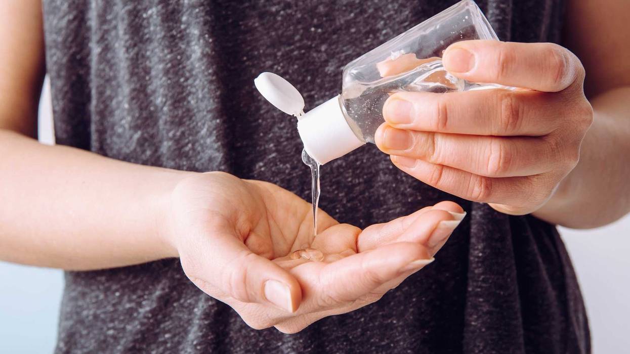 Person using small portable hand sanitizer.