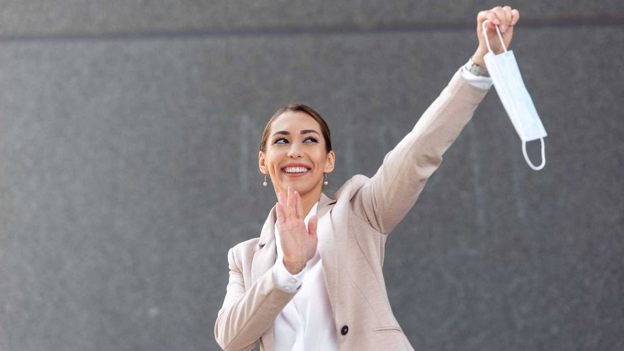 Person waiving at a mask.