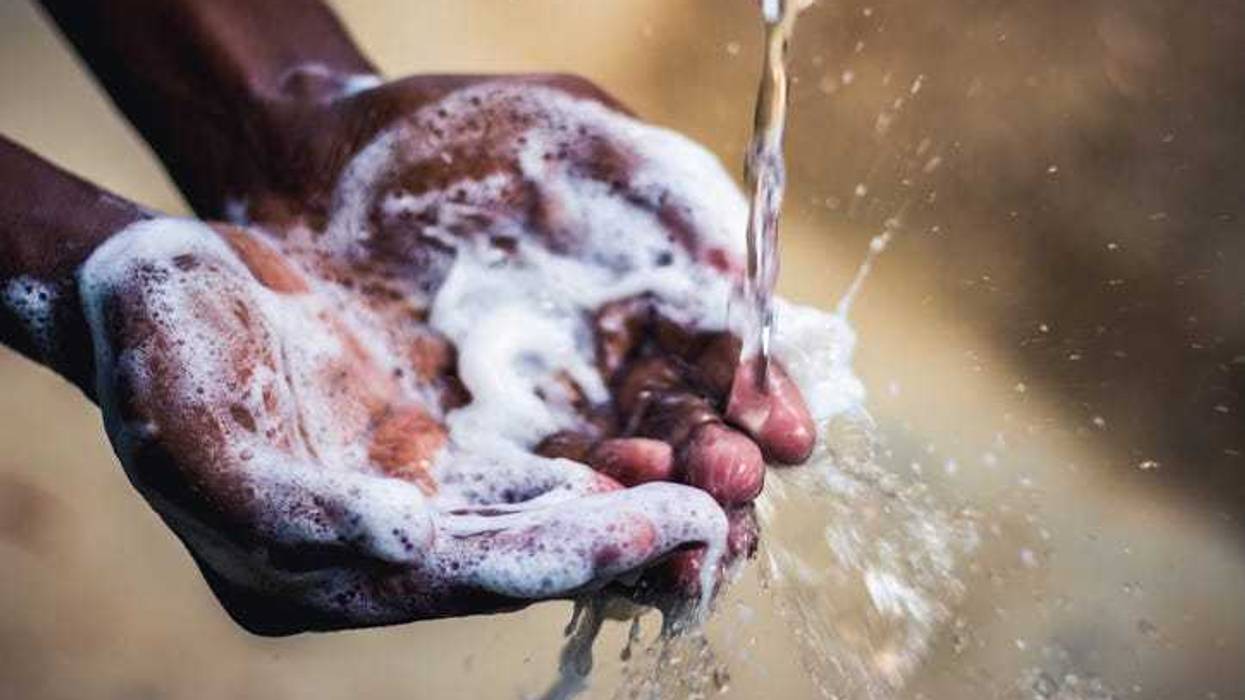 Person washing their hands.