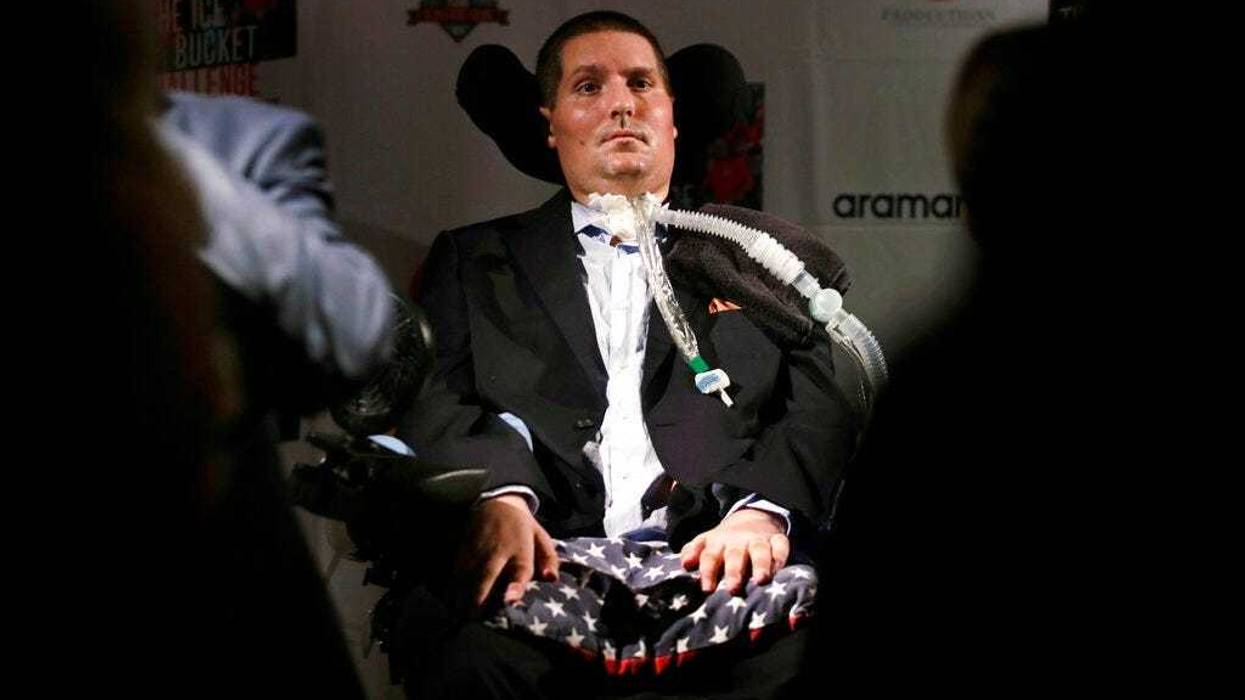 Pete Frates, who is stricken with amyotrophic lateral sclerosis, or ALS, listens to a guest at Fenway Park in Boston