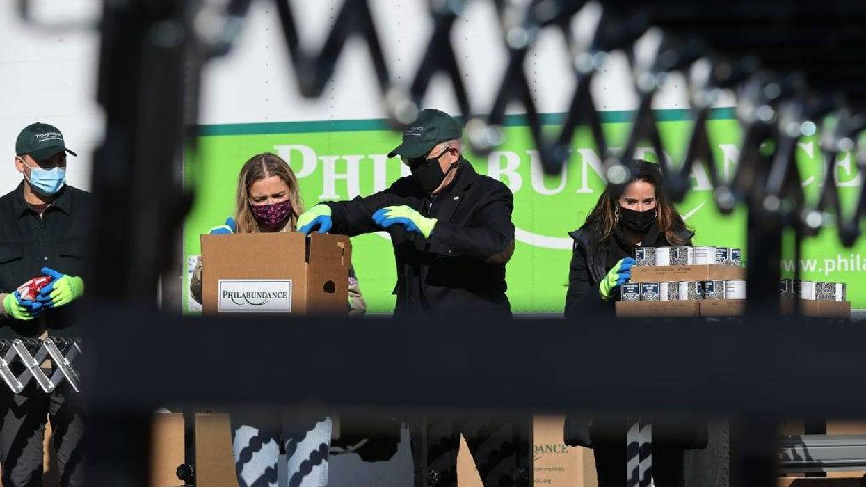 Peter Neal, Finnegan Biden, U.S. President-elect Joe Biden and Ashley Biden help fill food donation boxes at Philabundance