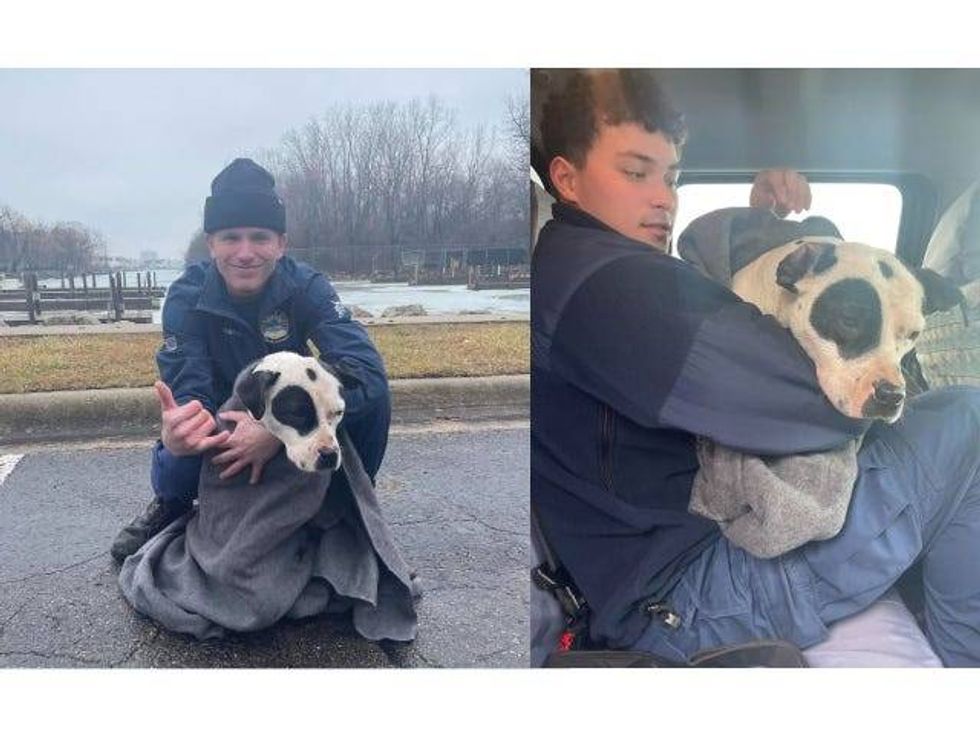 Petty Officer Cole Harper and another rescuer with the pup, who is wrapped up in a towel