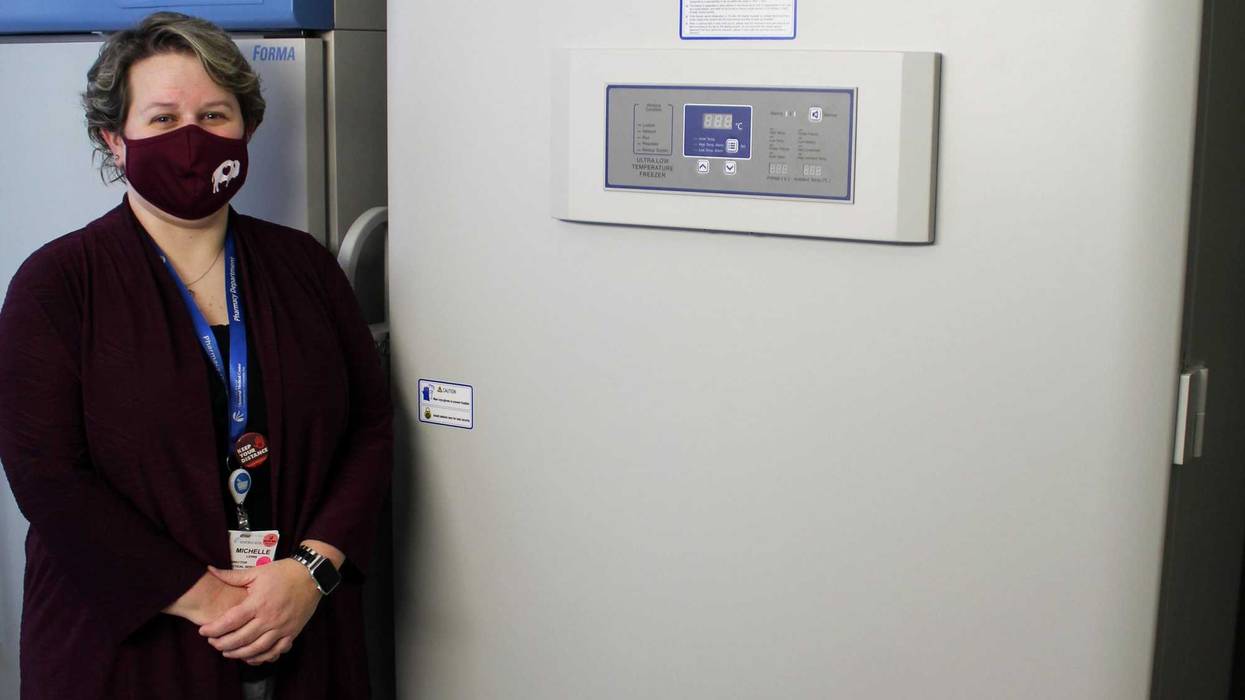 Pharmacy Director Michelle Lewis receives the special freezer for vaccine storage