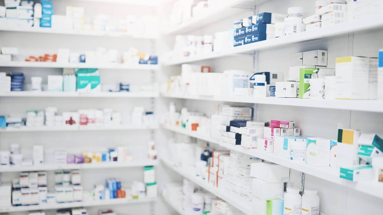 Pharmacy shelves filled with boxes and bottles of medications