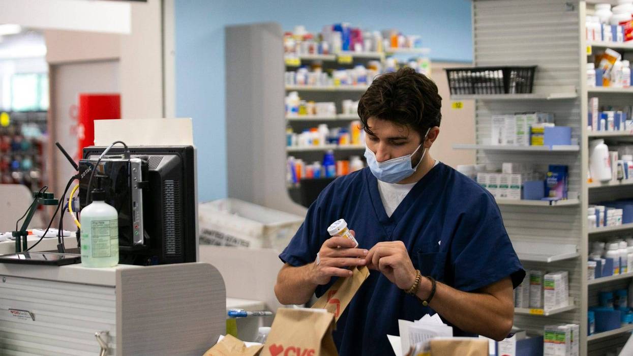 Pharmacy technician fills prescriptions at a CVS pharmacy