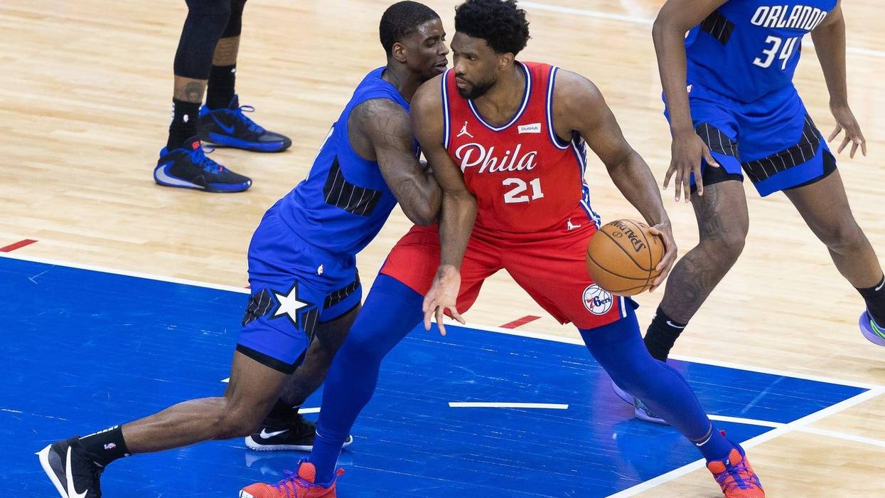 Philadelphia 76ers center Joel Embiid (21) drives against Orlando Magic guard Dwayne Bacon (8) during the third quarter at Wells Fargo Center.