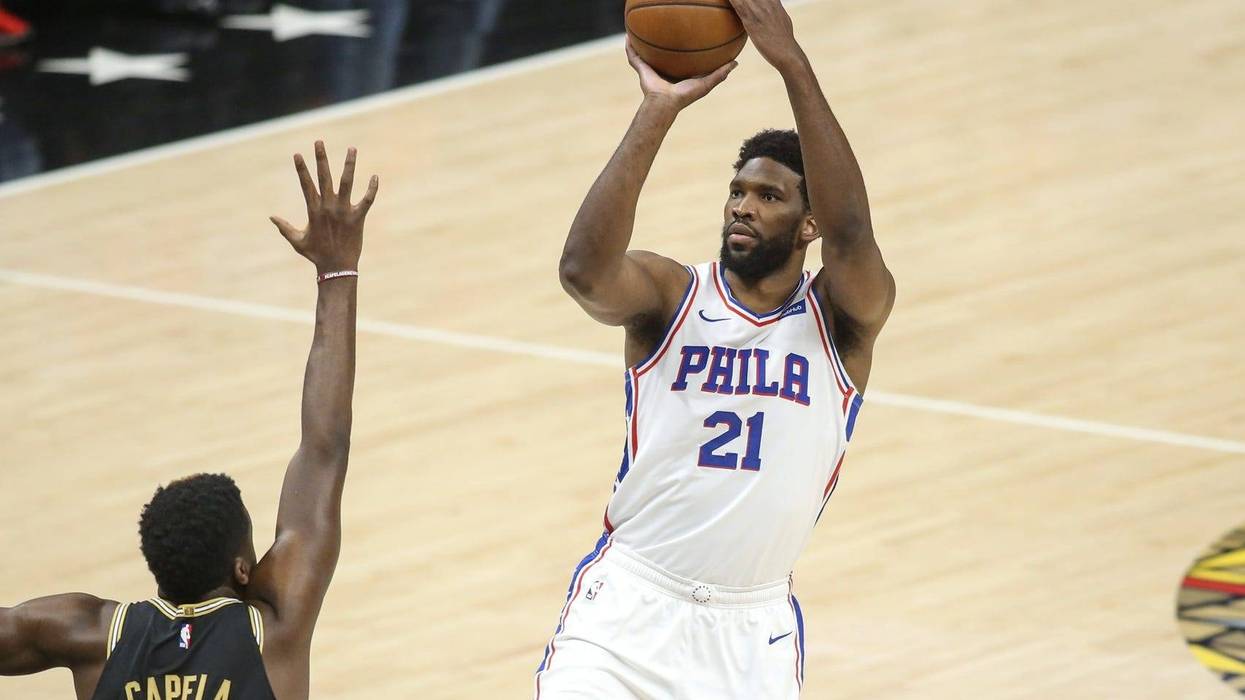 Philadelphia 76ers center Joel Embiid (21) shoots over Atlanta Hawks center Clint Capela (15)