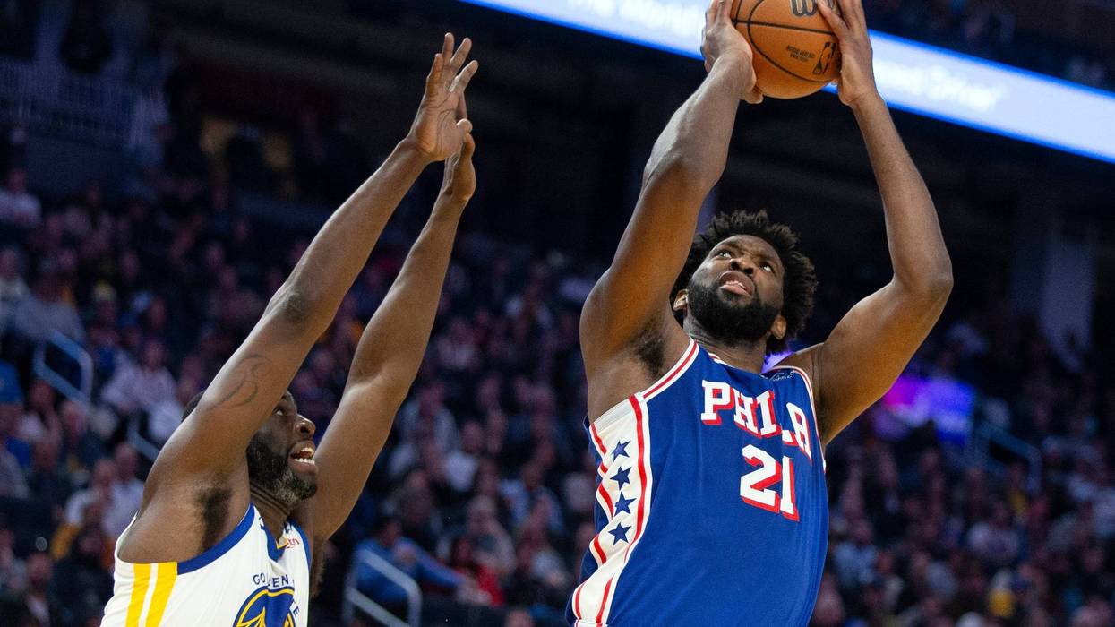 Philadelphia 76ers center Joel Embiid (21) shoots over Golden State Warriors forward Draymond Green (23) during the first half of an NBA basketball game, Jan. 30, 2024, in San Francisco.