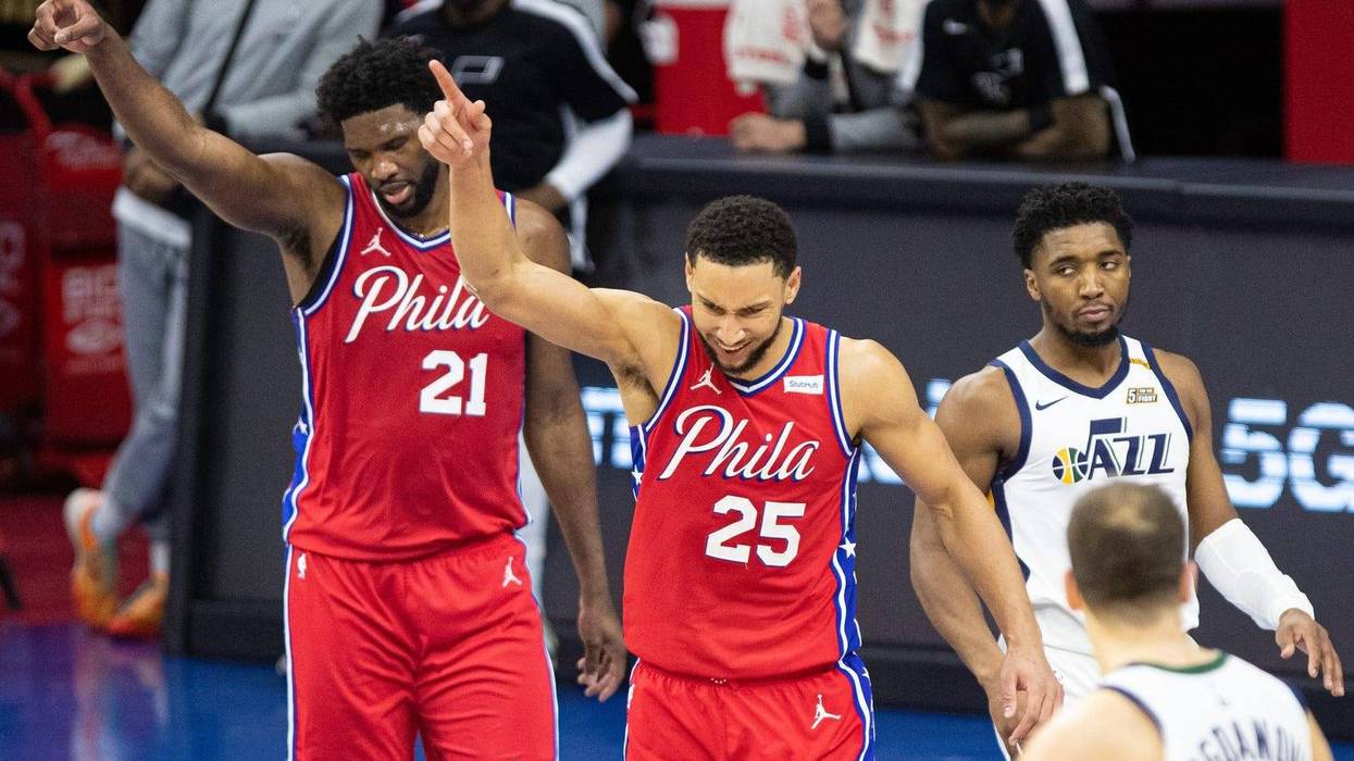 Philadelphia 76ers guard Ben Simmons (25) and center Joel Embiid (21) reacts in front of Utah Jazz guard Donovan Mitchell (45) after a turnover during overtime at Wells Fargo Center.