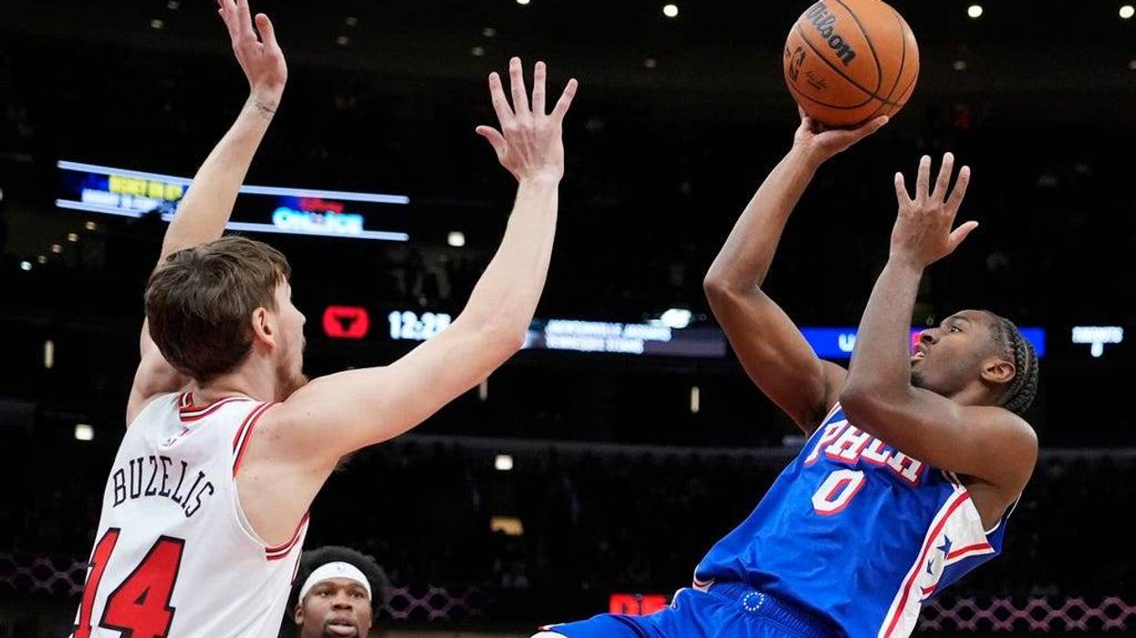 Philadelphia 76ers guard Tyrese Maxey, right, shoots over Chicago Bulls forward Matas Buzelis during the first half of an NBA basketball game in Chicago on Sunday.