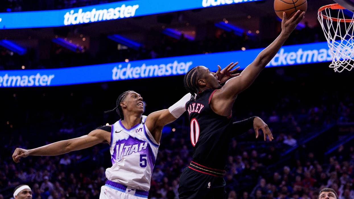 Philadelphia 76ers' Tyrese Maxey, right, goes up for the lay-up against Utah Jazz's Cody Williams, left, during the first half of an NBA basketball game, Wednesday, March 4, 2026, in Philadelphia.
