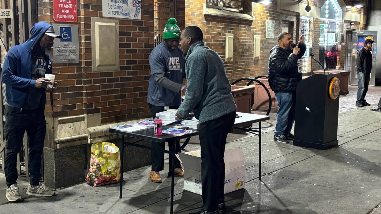 Philadelphia City Commissioner Omar Sabir (at podium) speaks at an event aimed at reaching morning commuters at the 52nd Street El station on Oct. 21, 2024.