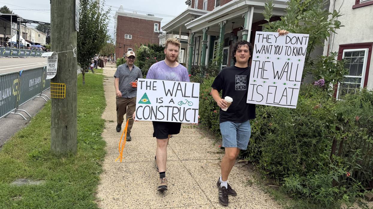 Philadelphia Cycling Classic fans walk to watch the race in Manayunk
