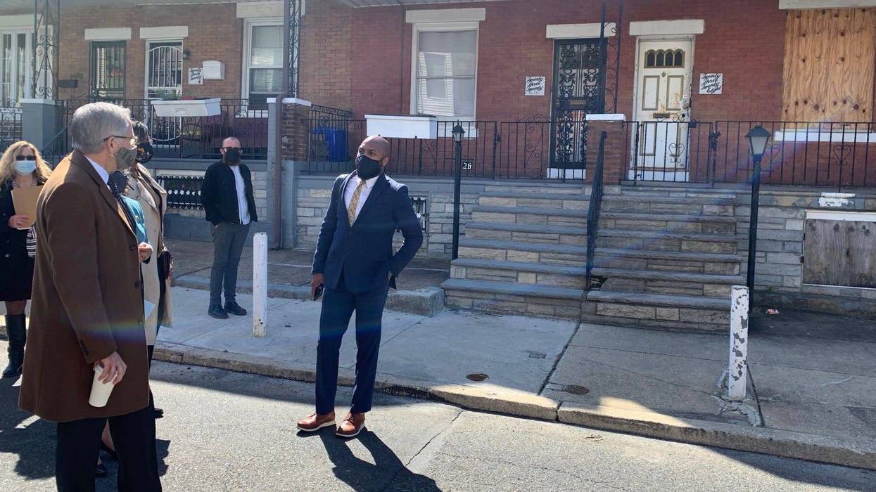 Philadelphia District Attorney Larry Krasner stands in front of a boarded-up Strawberry Mansion rowhome at the center of a case of house theft.