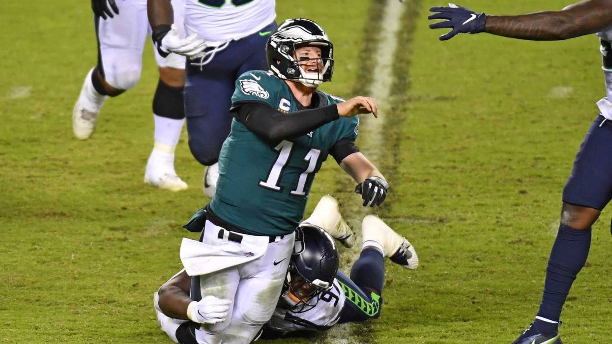 Philadelphia Eagles quarterback Carson Wentz (11) is pressured by Seattle Seahawks defensive tackle Poona Ford (97) during the fourth quarter at Lincoln Financial Field.