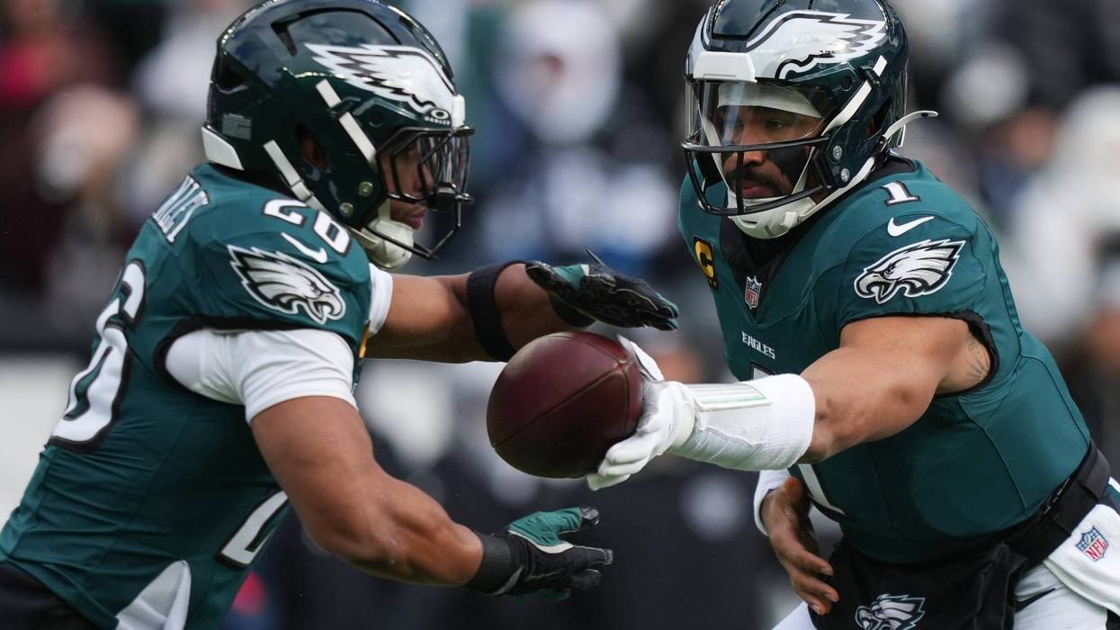 Philadelphia Eagles quarterback Jalen Hurts (1) hands off the ball to Philadelphia Eagles running back Saquon Barkley, left, during the first half of an NFL football game against the Las Vegas Raiders on Sunday, Dec. 14, 2025, in Philadelphia.