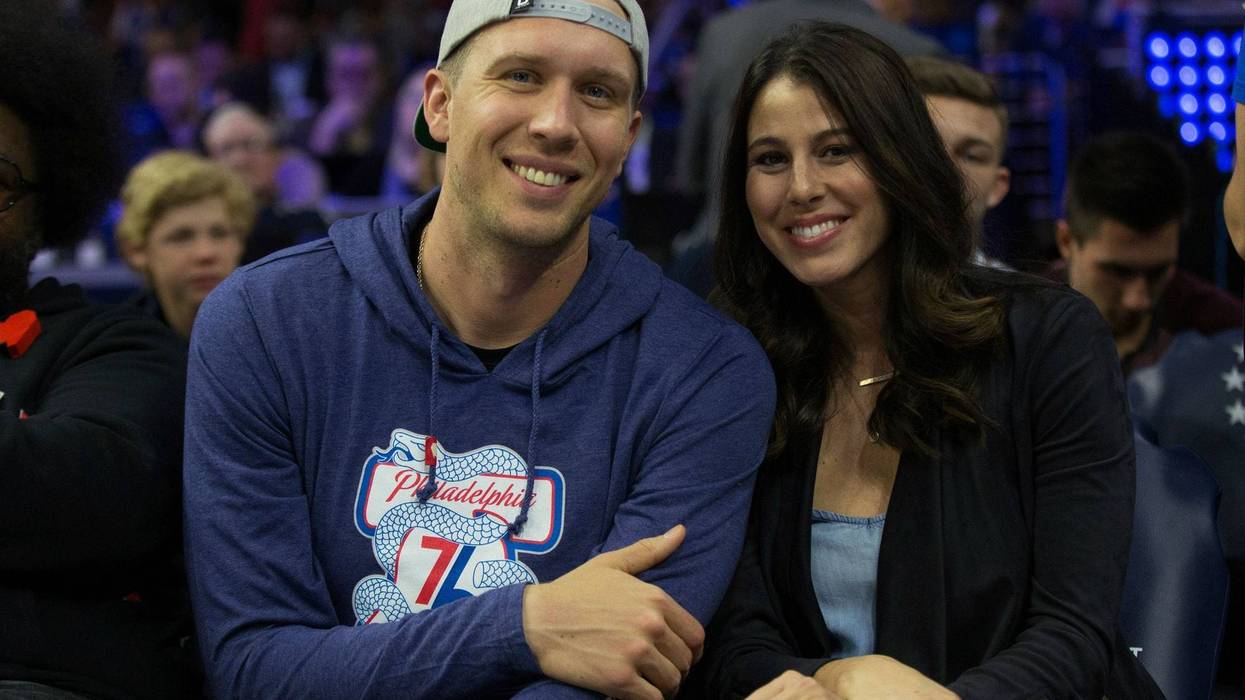 Philadelphia Eagles quarterback Nick Foles and his wife Tori Moore Foles look on during the third quarter in game three of the second round of the 2018 NBA Playoffs between the Philadelphia 76ers and the Boston Celtics at Wells Fargo Center.