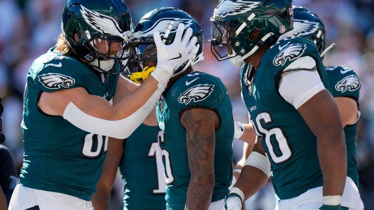 Philadelphia Eagles wide receiver DeVonta Smith, center, celebrates with teammates after catching a long touchdown pass from quarterback Jalen Hurts during the second half of an NFL football game against the Cincinnati Bengals, Sunday, Oct. 27, 2024 in Cincinnati.