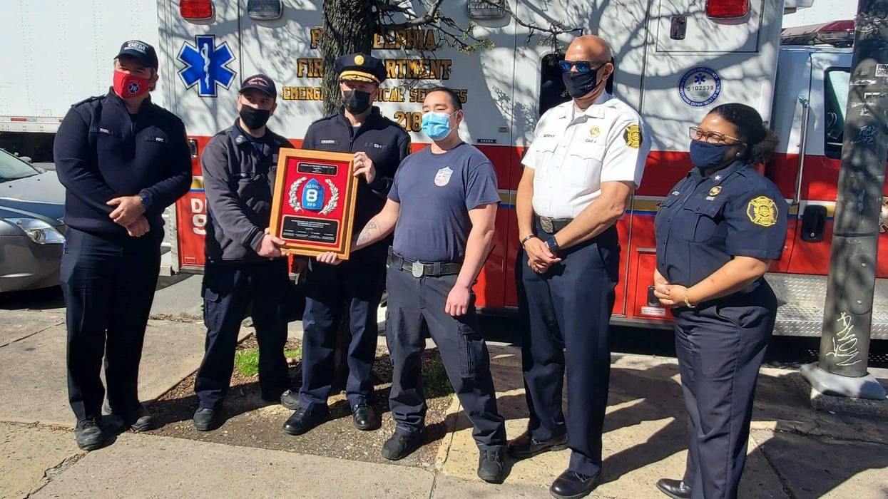 Philadelphia Fire Department officials along with members of the Medic 8 unit (left to right: Fire Commissioner Adam Thiel, EMT Michael Lasker, Paramedic Deputy Chief Eric Crouch, Paramedic James Lee, Deputy Commissioner Craig Murphy and Assistant Deputy Commissioner Crystal Yates) with a plaque naming them "America's Busiest Medic Unit."