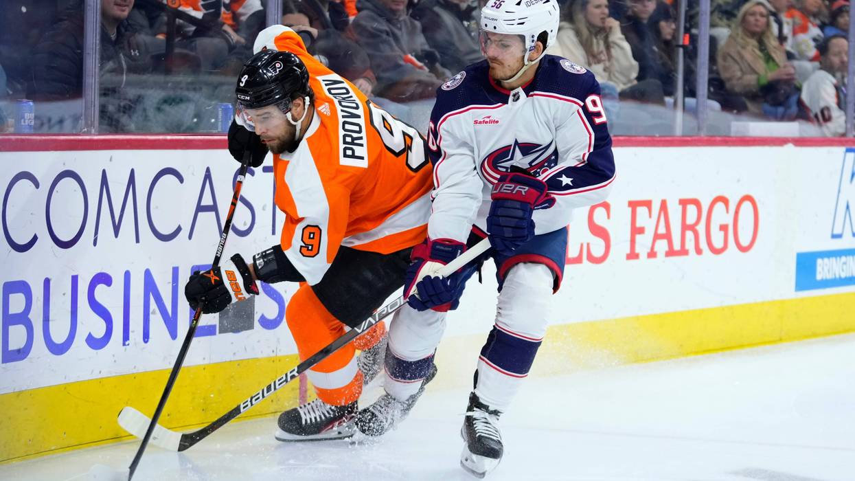 Philadelphia Flyers' Ivan Provorov, left, and Columbus Blue Jackets' Jack Roslovic battle for the puck during the first period of an NHL hockey game, Tuesday, Dec. 20, 2022, in Philadelphia.