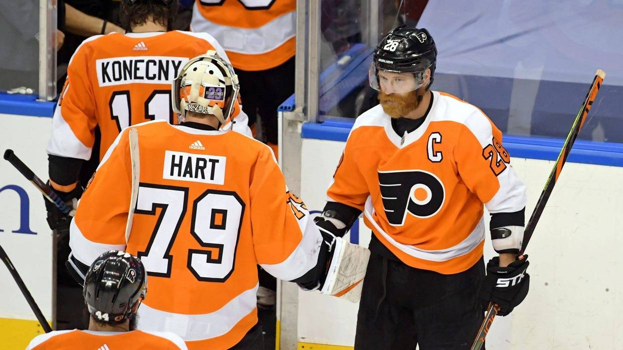 Philadelphia Flyers left wing Claude Giroux (28) shakes hands with goaltender Carter Hart (79) after their win over the New York Islanders.