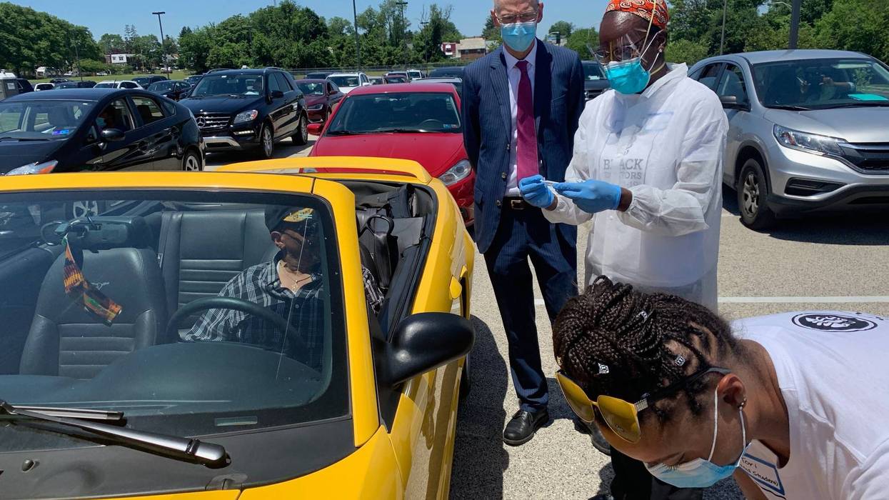 Philadelphia Health Commissioner Dr. Thomas Farley watches as Dr. Ala Stanford and an aide conduct COVID-19 testing at Enon Tabernacle Church.