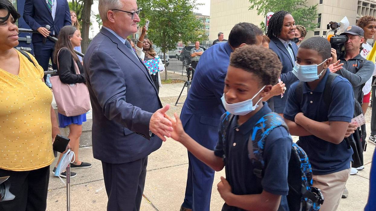 Philadelphia Mayor Jim Kenney high-fives students are they enter Dunbar School on their first day back of the 2022-23 year, Aug. 29, 2022.