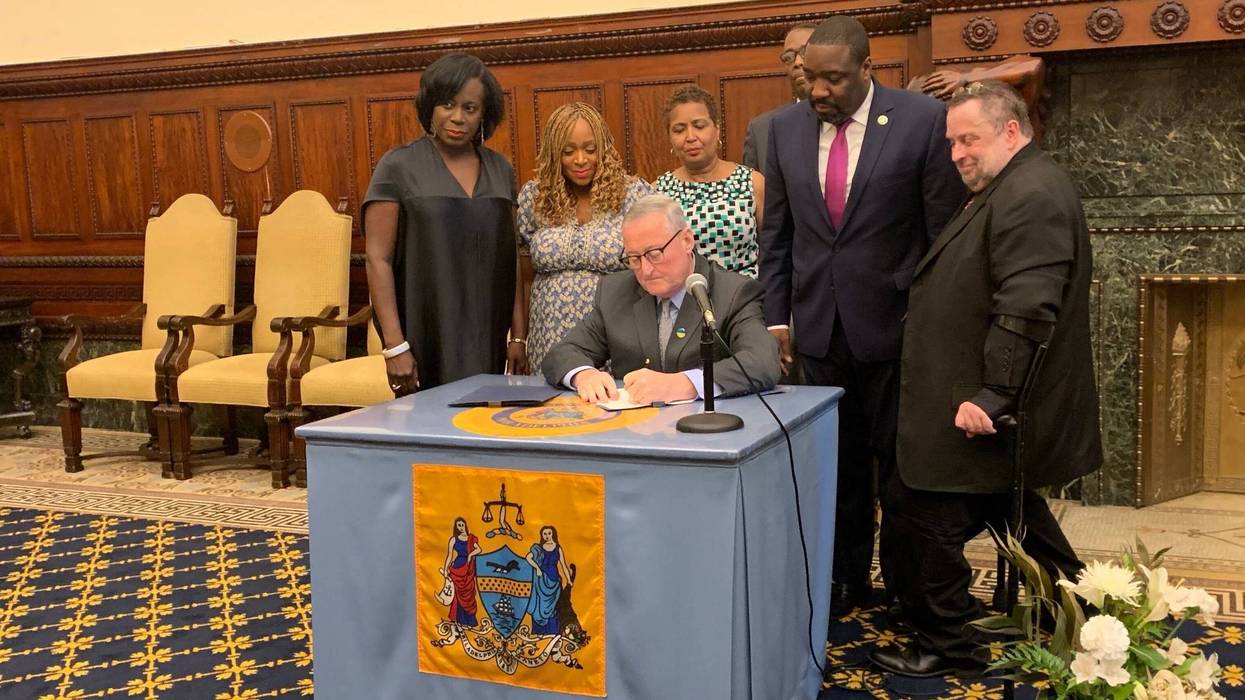 Philadelphia Mayor Jim Kenney signing property tax relief measures.