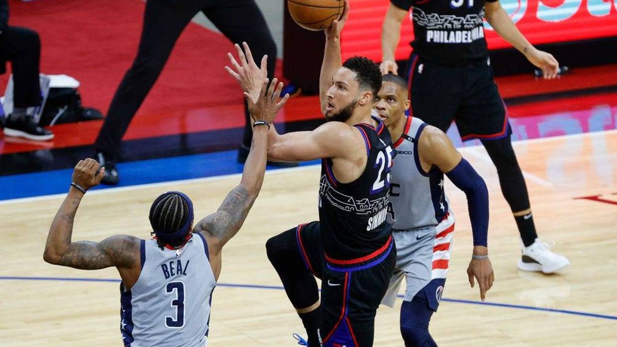 PHILADELPHIA, PENNSYLVANIA - MAY 23: Ben Simmons #25 of the Philadelphia 76ers shoots over Bradley Beal #3 of the Washington Wizards during the third quarter during Game One of the Eastern Conference first round series at Wells Fargo Center on May 23, 2021 in Philadelphia, Pennsylvania.