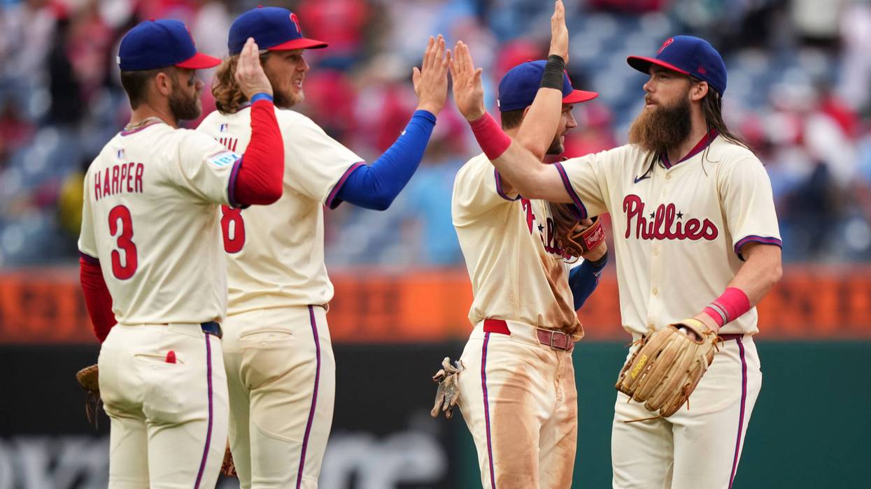 Philadelphia Phillies' Bryce Harper, from left, Alec Bohm, Trea Turner and Brandon Marsh celebrate after the Phillies won a baseball game against the Seattle Mariners Wednesday, Aug. 20, 2025, in Philadelphia.
