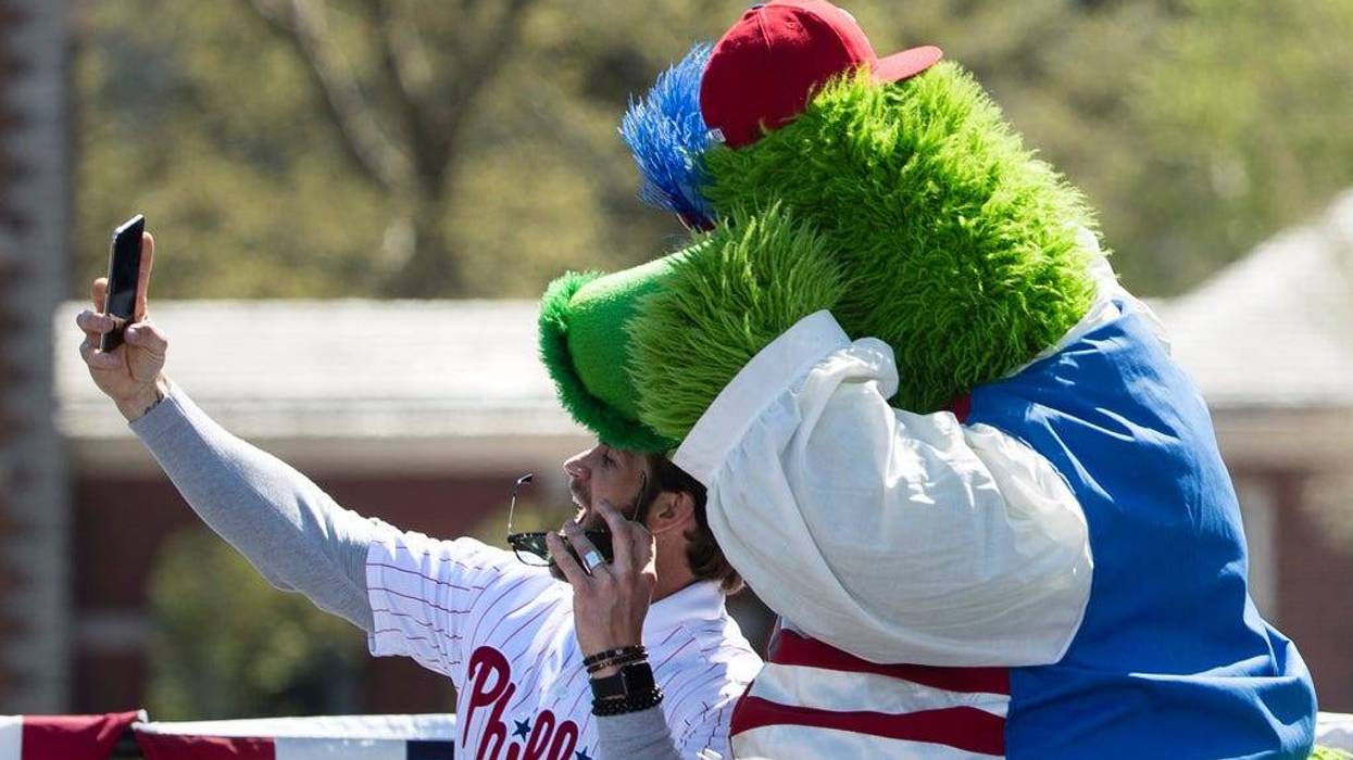 Philadelphia Phillies' Bryce Harper takes a selfie with the team mascot, the Phillie Phanatic