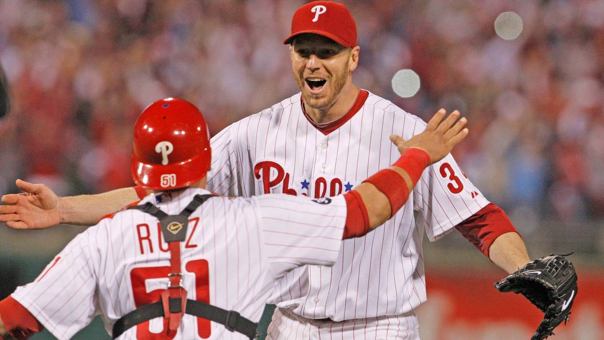 Philadelphia Phillies catcher Roy Halladay and catcher Carlos Ruiz celebrate a no-hitter, October 6, 2010.