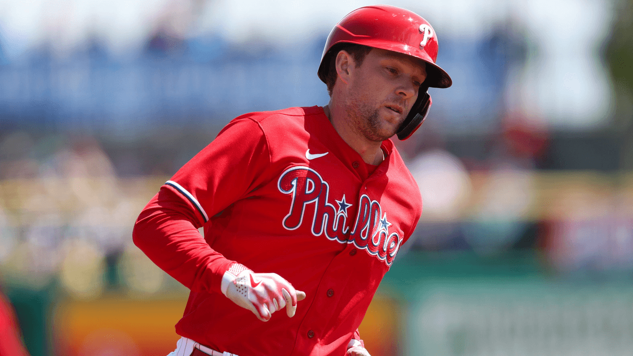 Philadelphia Phillies first baseman Rhys Hoskins running the bases in red Phillies uniform