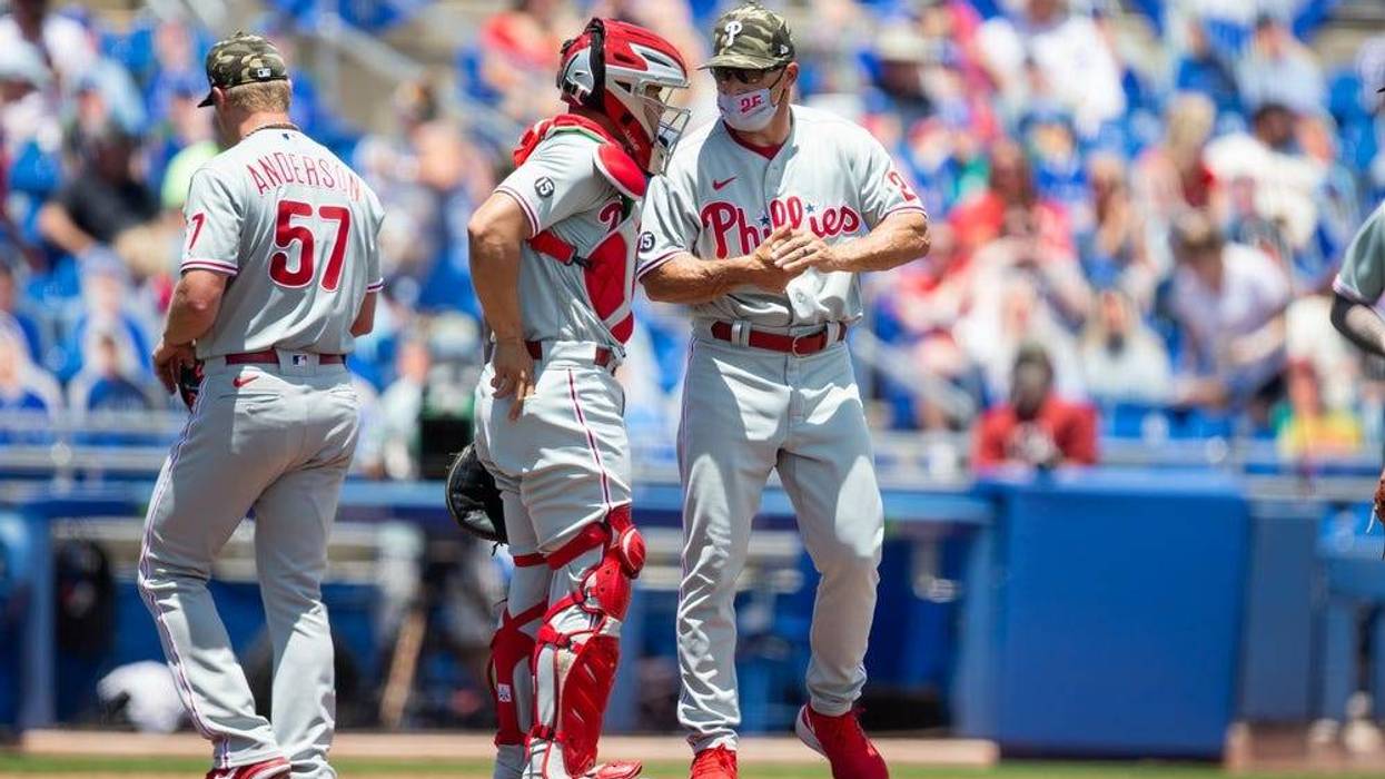 Philadelphia Phillies manager Joe Girardi (25) talks with catcher Rafael Marchan (12) during a pitching change in the second inning of a game against the Toronto Blue Jays at TD Ballpark.