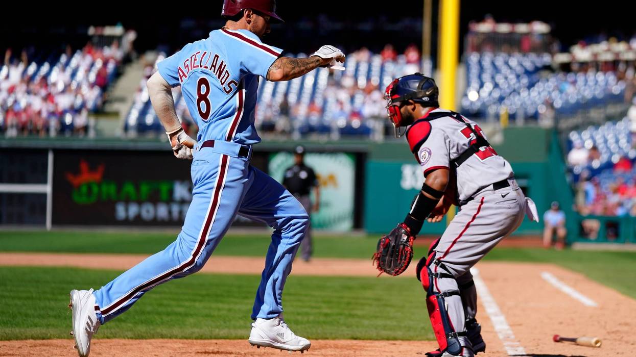Philadelphia Phillies' Nick Castellanos scores past Washington Nationals catcher Keibert Ruiz during the eighth inning of a baseball game, Aug. 7, 2022, in Philadelphia.