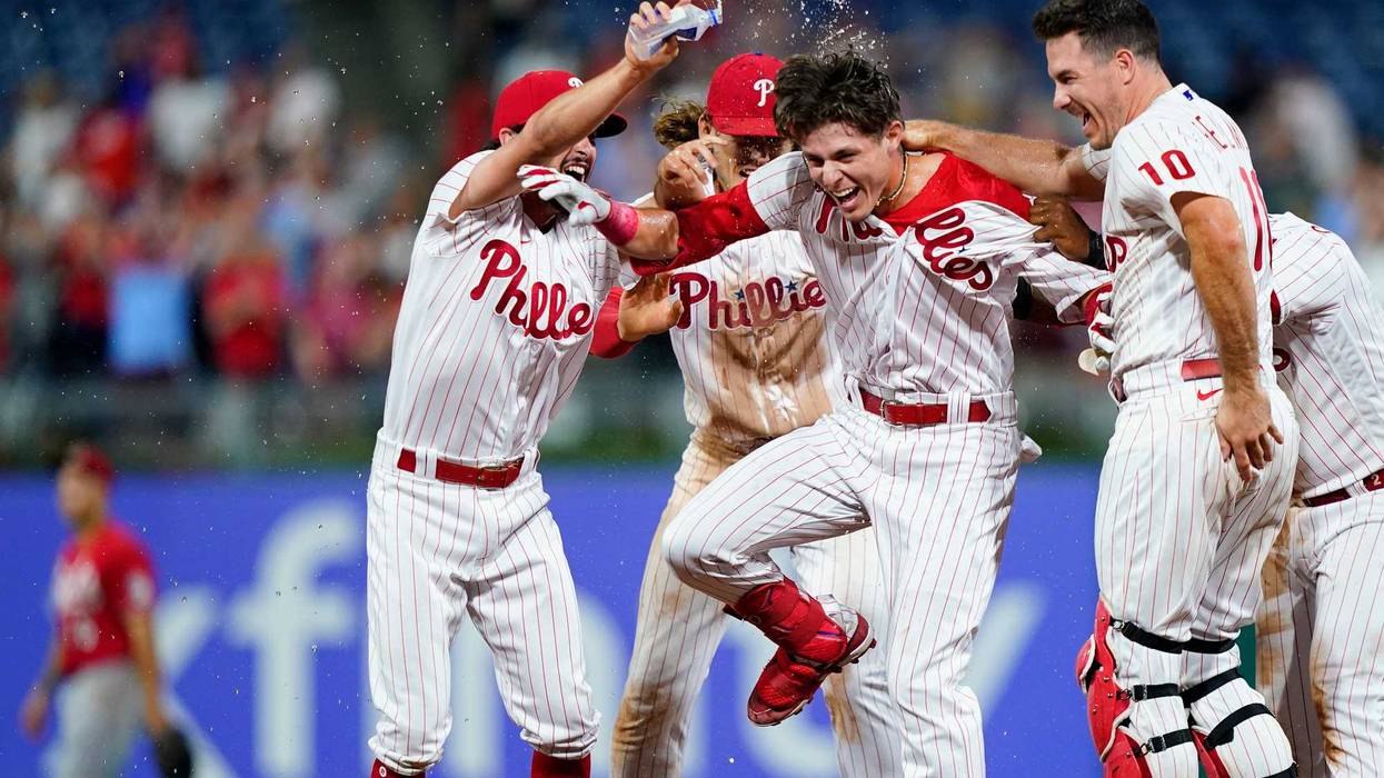Philadelphia Phillies' Nick Maton celebrates with teammates after hitting a game-winning RBI-single against Cincinnati Reds pitcher Alexis Diaz during the ninth inning of a baseball game, Tuesday, Aug. 23, 2022, in Philadelphia.