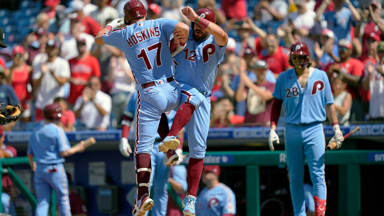 Philadelphia Phillies' Rhys Hoskins (17) celebrates with Kyle Schwarber after hitting a two-run home run off of Washington Nationals relief pitcher Cory Abbott during the fourth inning of a baseball game, Sunday, Aug. 7, 2022, in Philadelphia.