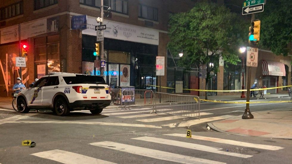 Philadelphia police are shown at Third and South streets at the beginning of their investigation into Saturday