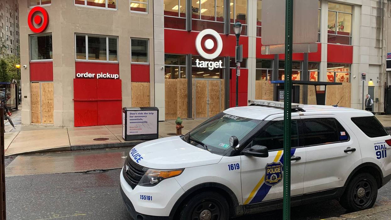 Philadelphia police are stationed at intersections throughout Center City, and many businesses are closed or boarded up on Friday.