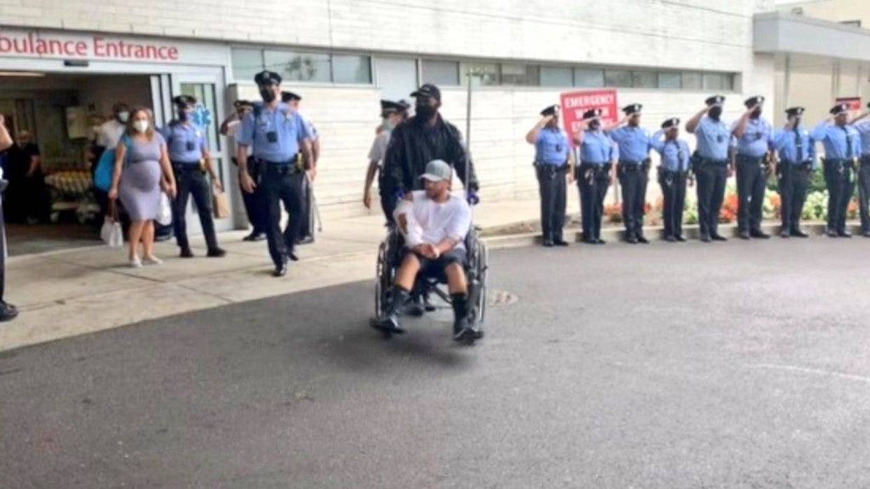 Philadelphia police officer Arcenio Perez, being taken in a wheelchair from Penn Presbyterian Medical Center after his recovery from being shot during an exchange of gunfire on October 4.