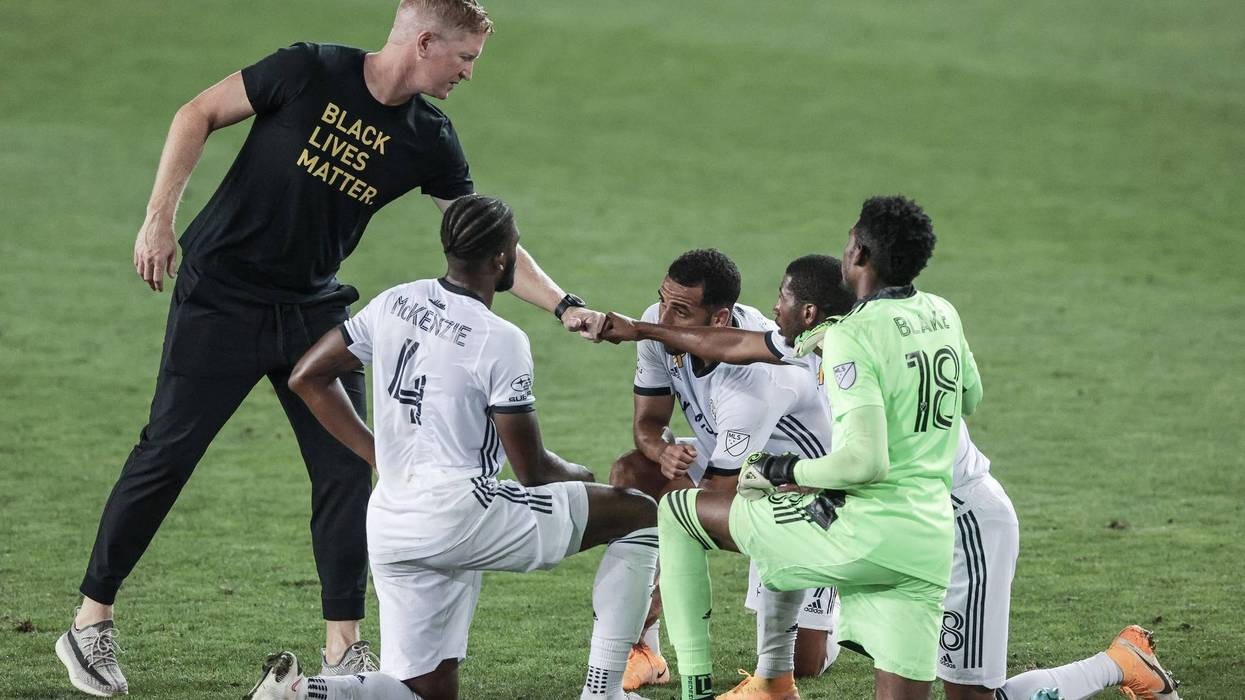 Philadelphia Union head coach Jim Curtin fist bumps defender Ray Gaddis (28) in front of goalkeeper Andre Blake (18) and defender Mark McKenzie (4) during the second half at Red Bull Arena.