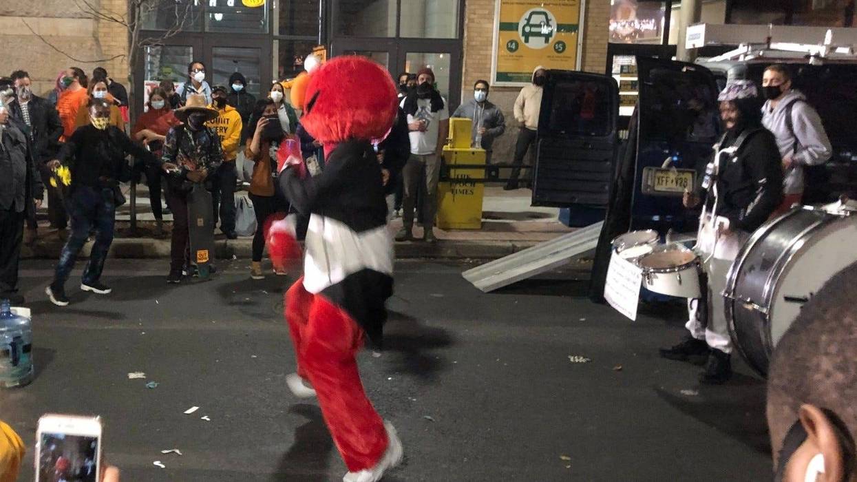 "Philly Elmo" leads the Positive Movement Entertainment drumline through Center City.