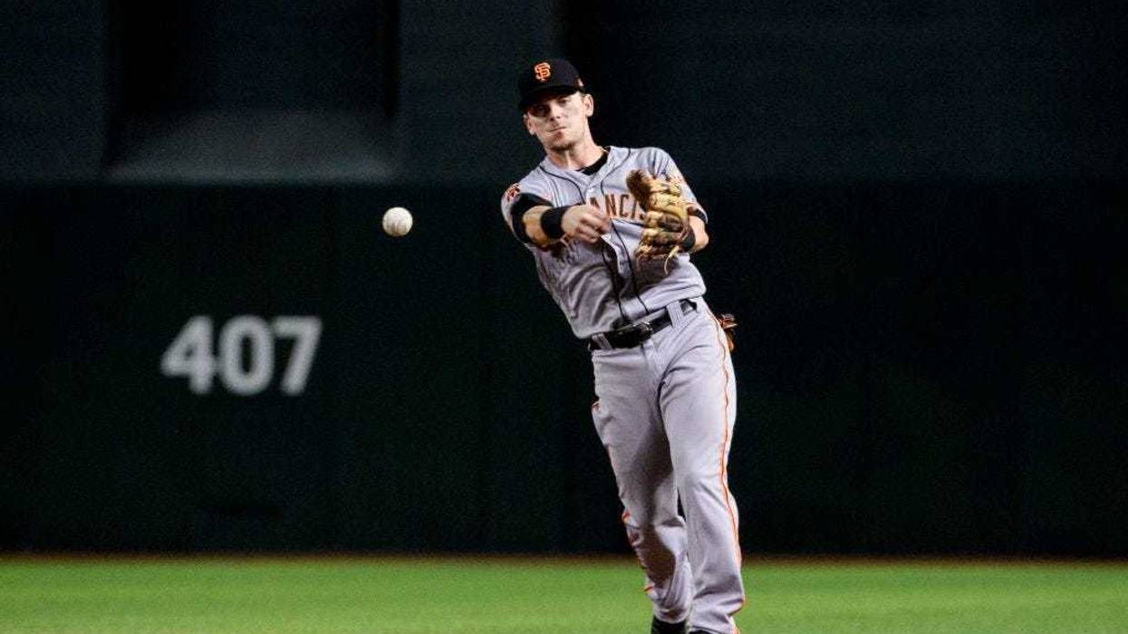 PHOENIX, ARIZONA - AUGUST 15: Scooter Gennett #14 of the San Francisco Giants makes the out at first in the ninth inning of the MLB game against the Arizona Diamondbacks at Chase Field on August 15, 2019 in Phoenix, Arizona. The San Francisco Giants won 7
