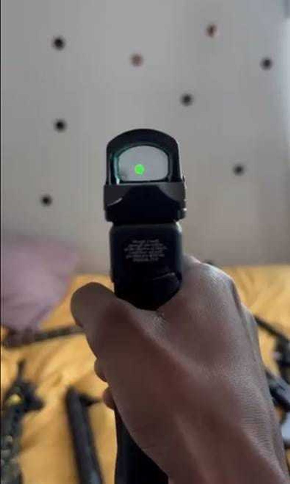 Photo of a pistol with a laser beam as part of the evidence provided in indictments charging over a dozen people in a series of East Harlem gang shootings.